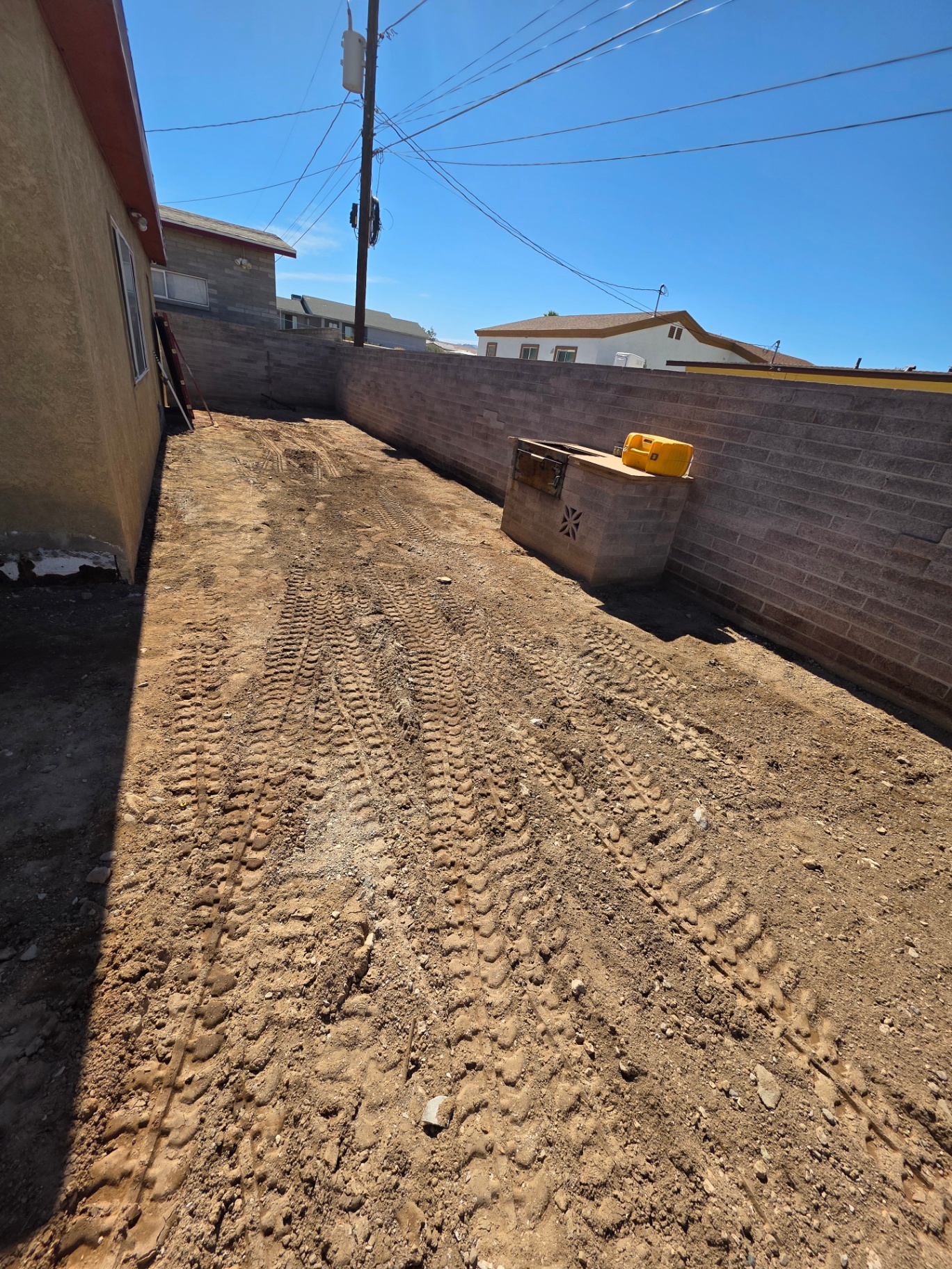 Graded and compacted side yard ready for a concrete pour