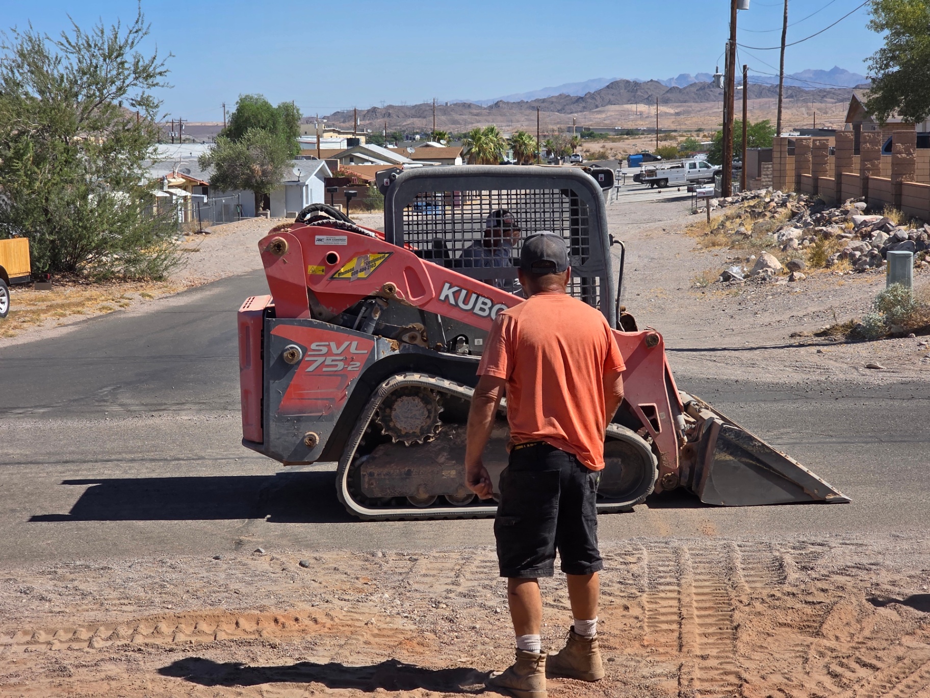 Crew operating a Kubota SVL75-2 track loader on a Bullhead City job